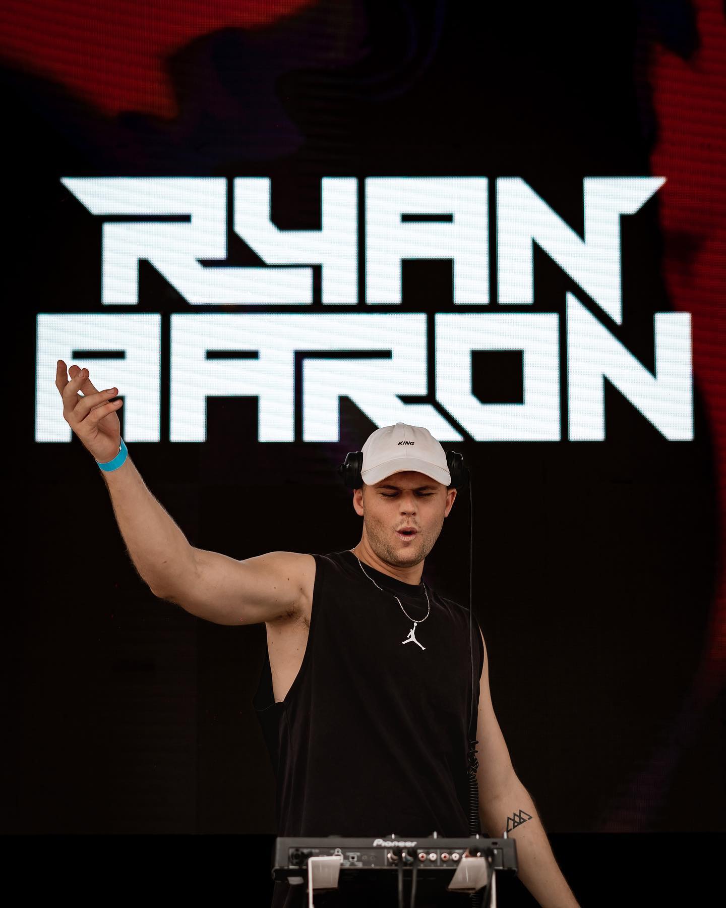 Ryan Aaron performing as a DJ with his artist logo